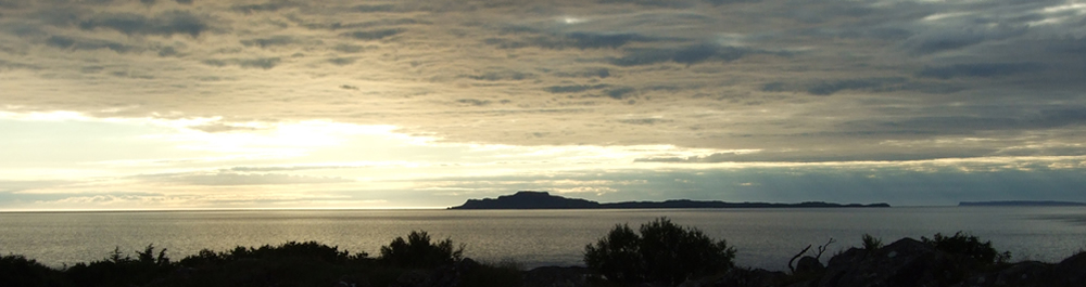 Sunset over Muck from Self catering holiday house Ardnamurchan Scotland
